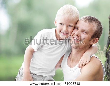 happy  family; young father and his five year old son spending time outdoor on a summer day