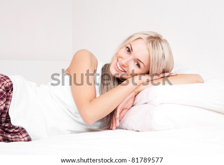 beautiful young blond woman on the bed at home
