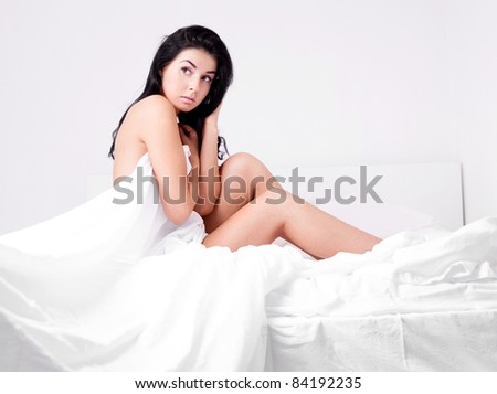 sexy young brunette woman  on the bed at home