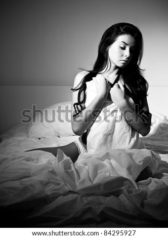 lonely young  woman  in her bed at home at night