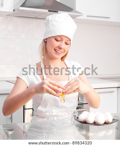 pretty young woman baking bread  in the kitchen at home