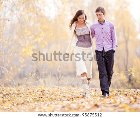 low contrast portrait of a happy loving couple walking  outdoor in the autumn park