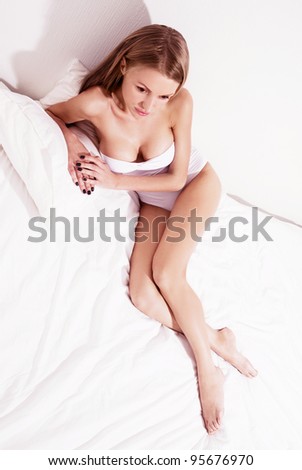 sexy young woman relaxing in  bed at home (top view)