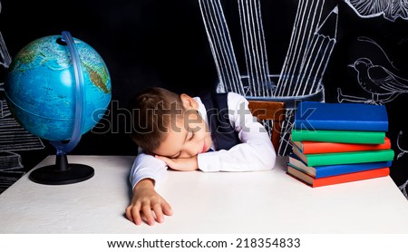 seven year old school boy sleeping at the lesson
