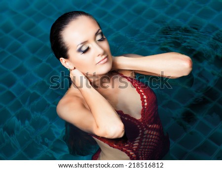 beautiful brunette woman in the swimming pool, top view