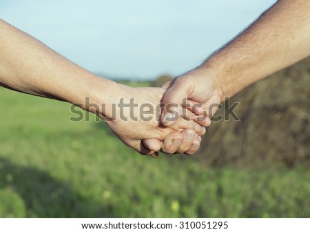 happy smiling couple: sixty eight year old man and sixty five year old woman isolated against blue background