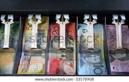 Open cash drawer filled with various Australian currency notes