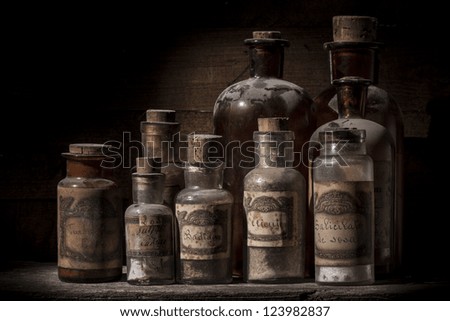 Antique pharmacy jars over wood table