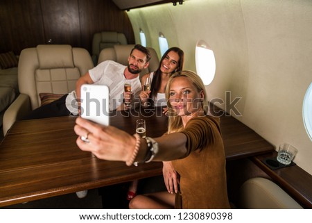 Happy group of friends having party on a luxury private jet