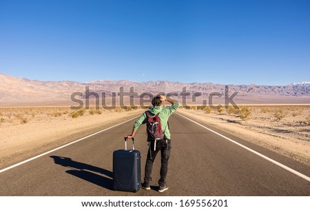 Single man walking alone into the desert
