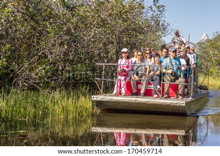 EVERGLADES - NOVEMBER 30,2013:  tourists on airboat.Everglades National Park in South Florida has stopped issuing new permits for private airboats