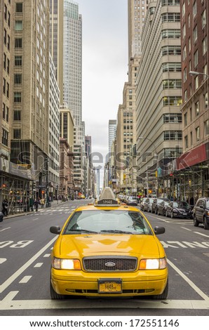 NEW YORK - DECEMBER 22, 2013: yellow taxi in Manhattan,New York. The city is planning to replace its fleet of various kinds of taxis with one model.