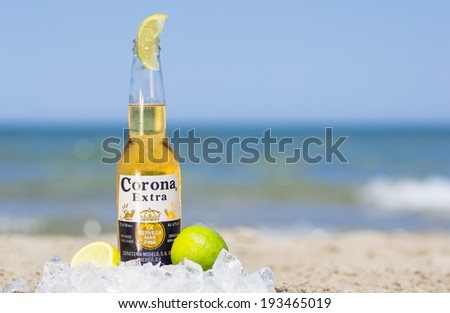 Rimini,rivazzurra,It. May 18, 2014. Corona bottle on the beach.Corona Extra is a pale lager produced  in Mexico for domestic distribution and export to all other countries besides the USA.