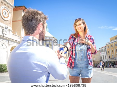 Man on knee giving to his girlfriend a ring - wedding proposal