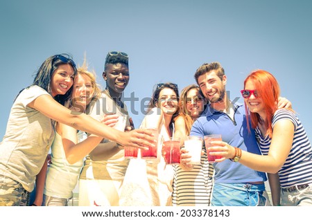 Group of happy friends drinking cocktails