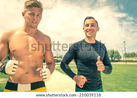 Two young men running outdoors