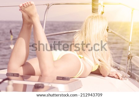 woman on a yacht having sunbath