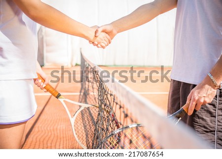 Handshake at tennis court - agonism,respect,fair play,sport concept