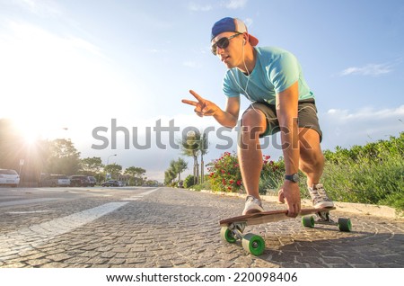 Sportive cool an on a skateboard - cool street skateboarder in a urban setting - fashion,sport,lifes tyle concept