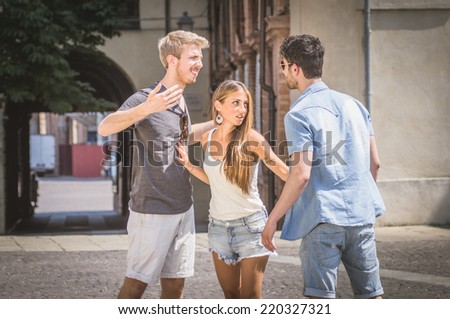 friends fighting in the city square. concept about jealousy. they fights because of the girl, no one wants to give up