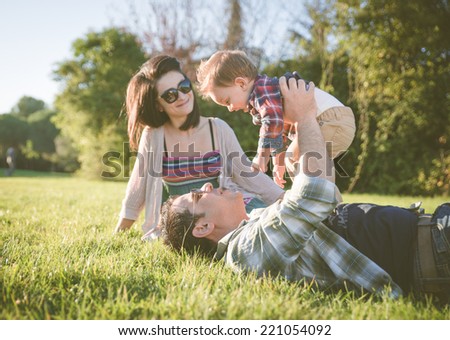happy family portrait. Young parents in a park with their one year old kid