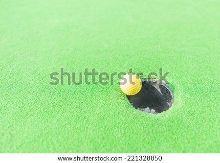 golf ball getting in the hole. concept about sport,goals and success
