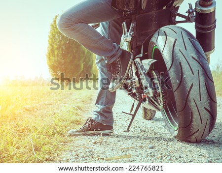 biker taking a break in the countryside. concept about motorbikes