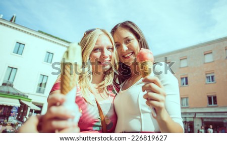 two girls eating ice cream. concept about friendship, food, and city life