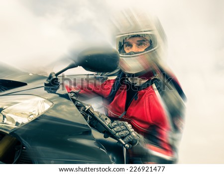biker riding fast on his sport motorbike. speed blur effect