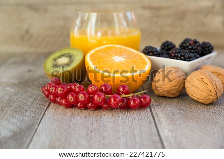 Composition of citrus fruits,berries and nuts on wooden background