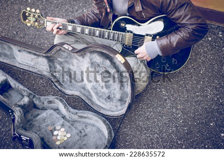 street artist playing guitar on the street. concept about people and street art