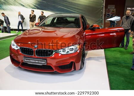 MILAN, IT. NOVEMBER 5, 2014. The new BMW m4 exposed at EICMA 2014. The BMW M4 is a high-performance version of the 4 Series automobile developed by BMW\'s in-house motorsport division.