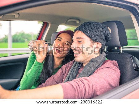 happy couple singing in the car. concept about love and couples