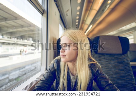 woman in the train looking outside the window.. concept about people and transportation.