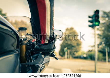 Motorcyclist on the road - Racing motorbike stops at traffic lights