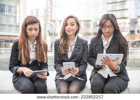 Business women of different ethnicity working with tablets - Women sitting outdoors - Business,technology,multiracial concepts