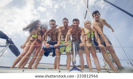 friends making party on a boat. concept about friendship and fun in the nature