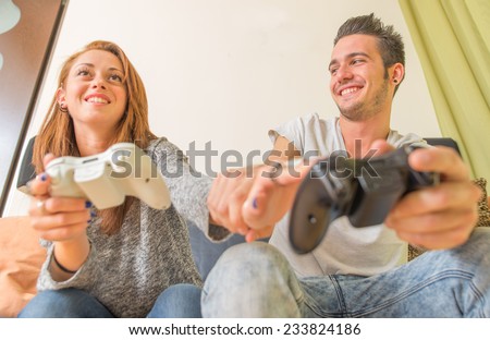 couple playing video games at home. concept about technology and home entertainment
