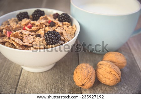 Milk and muesli with berries - Healthy breakfast with fresh natural ingredients - Close up on breakfast table