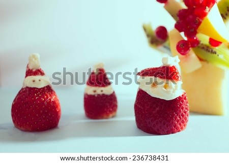 strawberry santa claus and christmas tree. concept about food and christmas