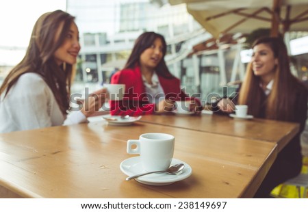 three friends having a coffee in a bar. concept about friendship and free time