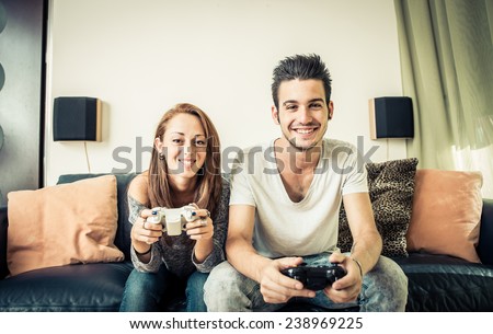 young couples playing video games on the living room. concept about home entertainment