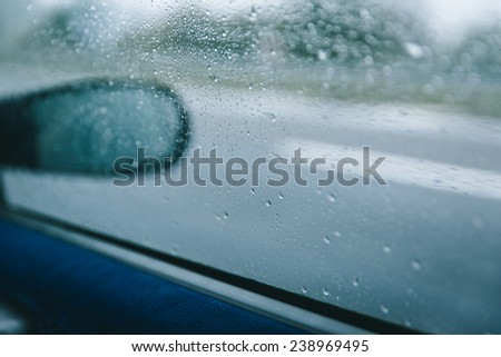 water drops on the car side screen. concept about bad weather and transportation