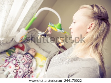 Mom looking at her son while sleeping - Mother singing a lullaby to her baby