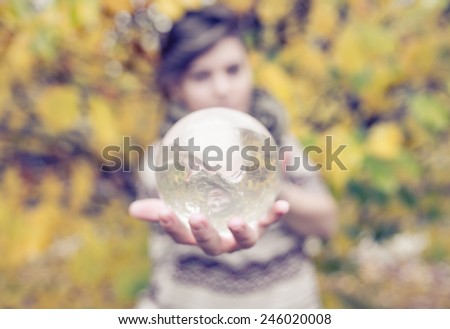 woman holding contact juggling glass sphere