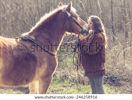 young woman kissing her horse. concept about people and animals