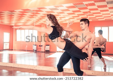 Gymnastic athletes training in a gyms - Couple of dancers performing a ballet duo