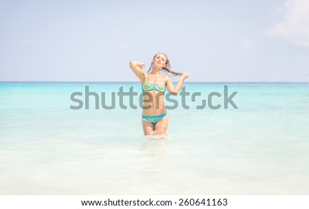beautiful woman coming out from the clear sea in similan island, thailand