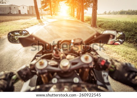 riding fast on the country side area. motorcycle rearing during full acceleration