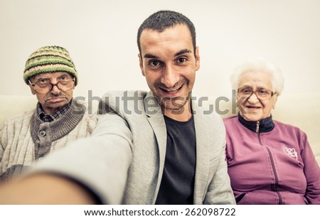 happy family portrait. grandson taking selfie with grandparents. concept about fun, family,aging,old people,seniority, technology,selfie and lifestyle